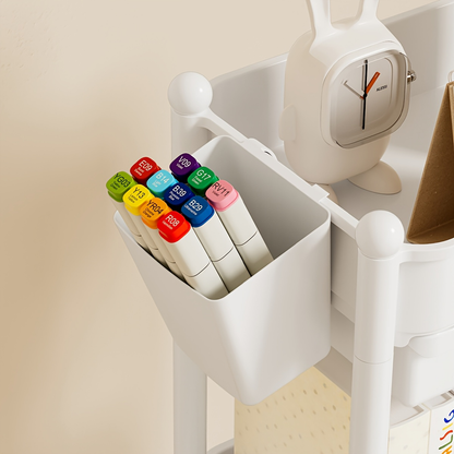 Three-tiered bookshelf with wheels, and includes two pen holders.